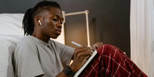 Student Writing in Bedroom